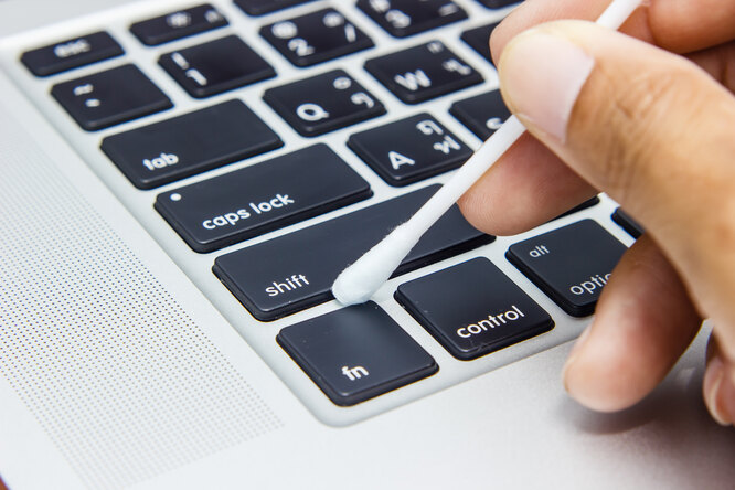 Use cotton swabs to clean the keys